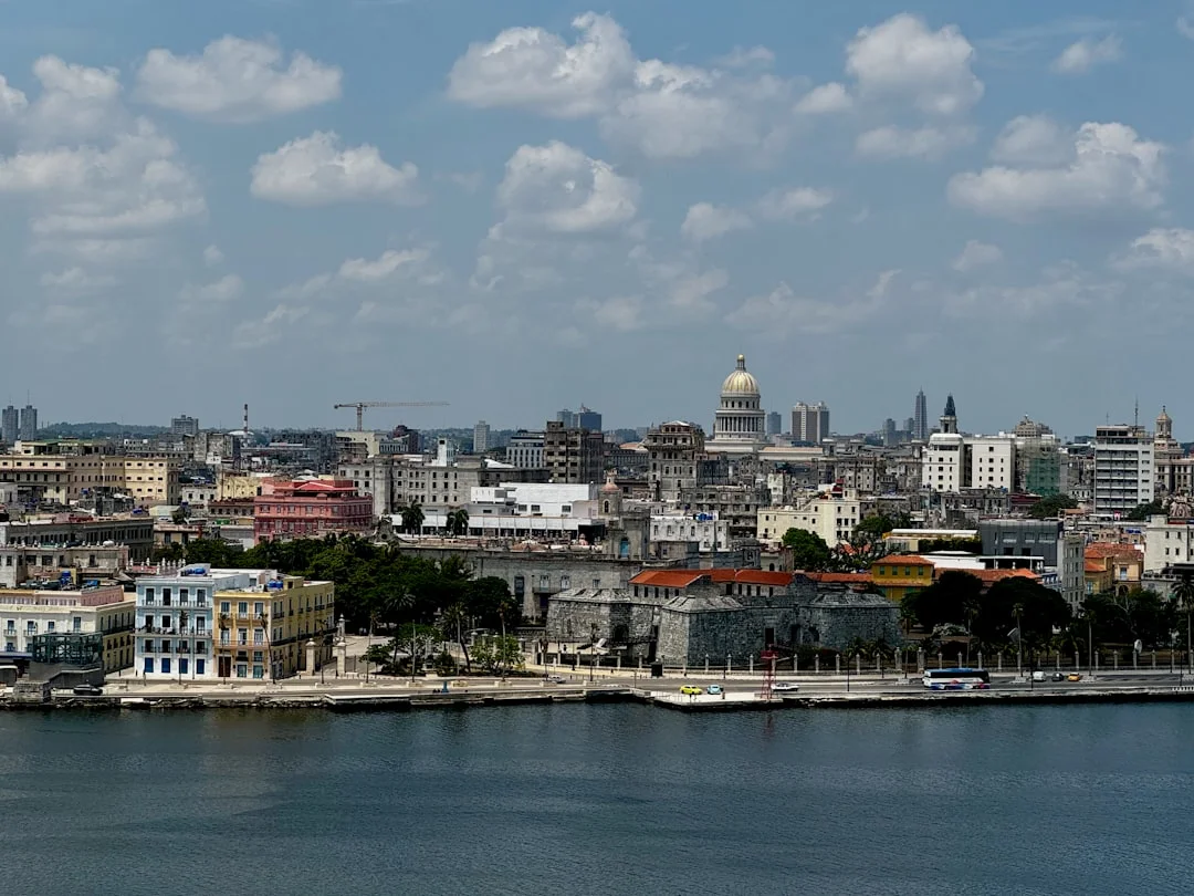 Panoramic view of Havana’s historic skyline with the El Capitolio dome rising above colorful colonial buildings along the Malecón waterfront showcasing Cuba's unique blend of architecture, history, and Caribbean charm.
