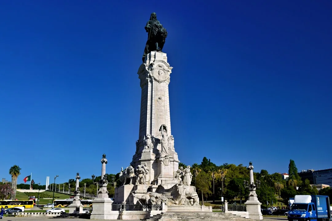 Monument with equestrian statue under a clear blue sky.