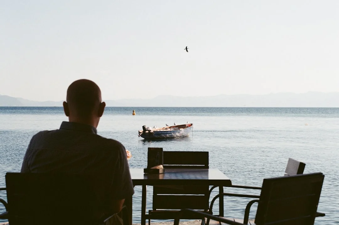 Man drinking coffee with a view of Ohrid Lake