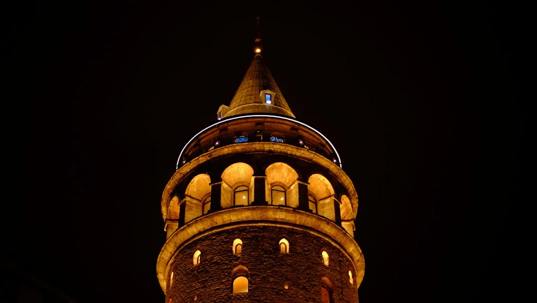 Galata tower illuminated at night against dark sky