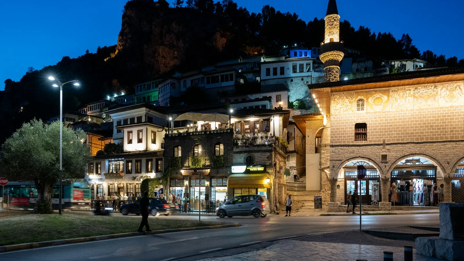 Nighttime view of a historic city with a mosque.