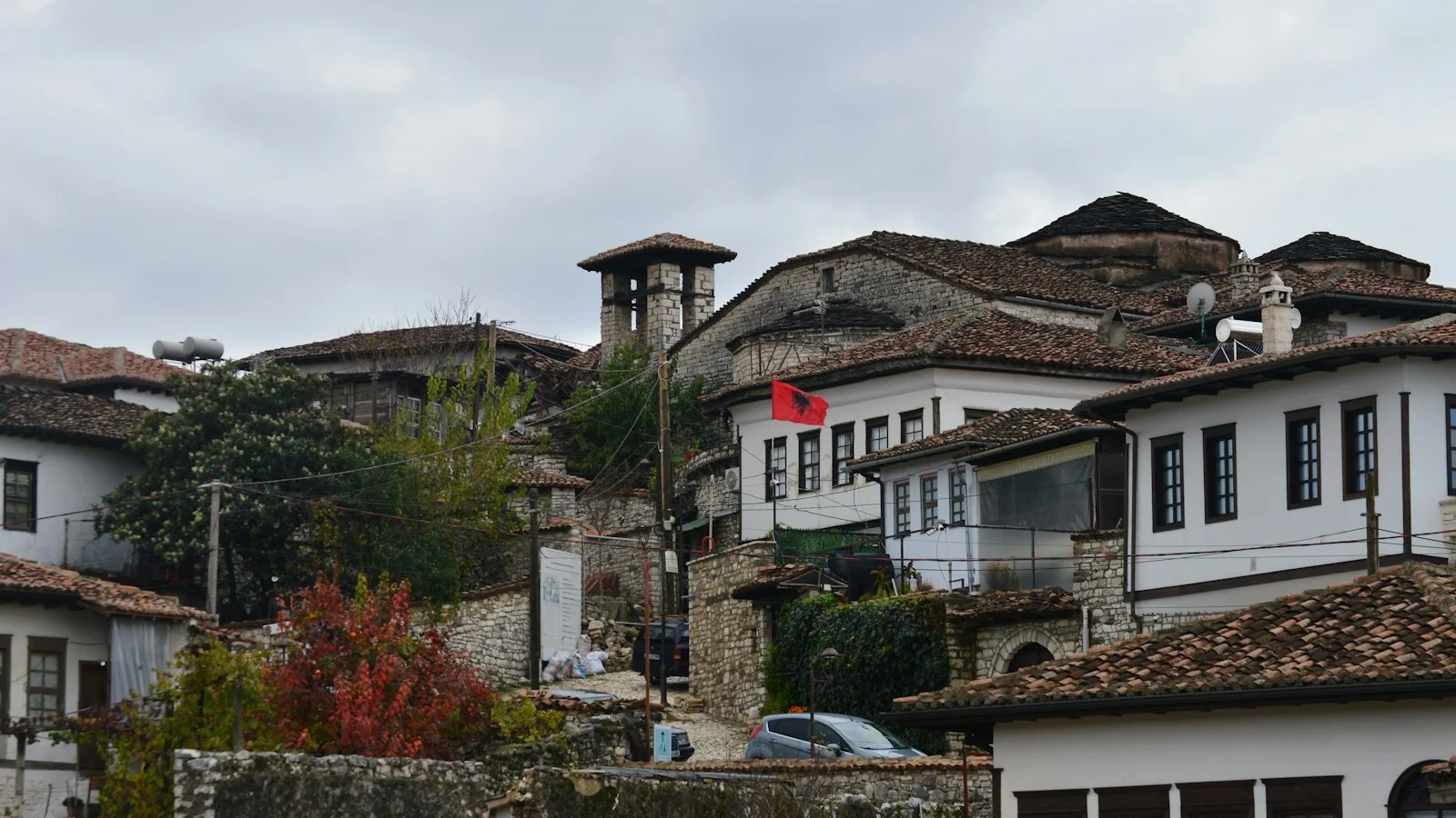 White houses with tiled roofs on a hill.