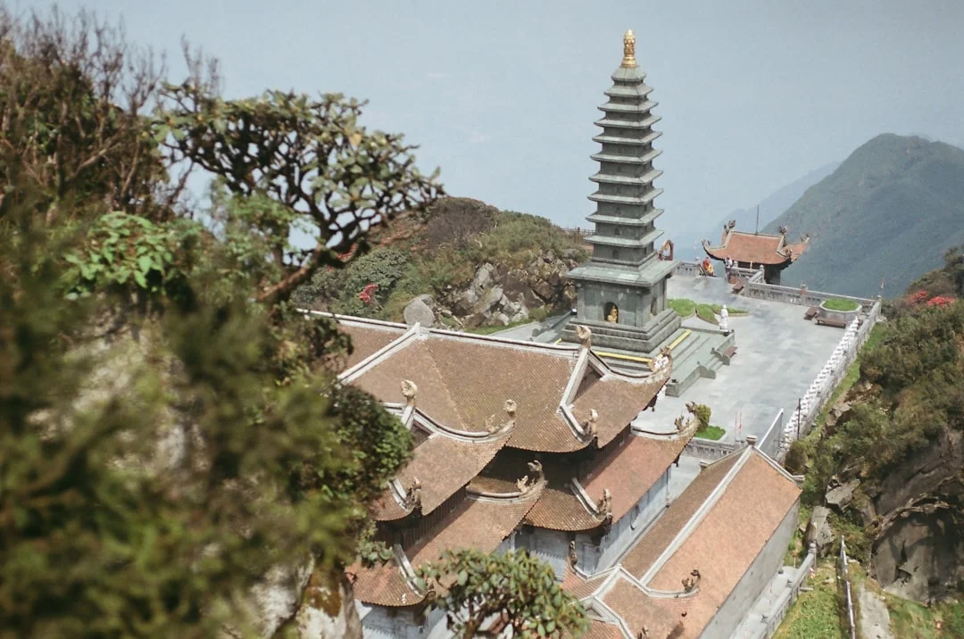 Buddhist Pagoda on Mount Fansipan, Vietnam Buddhist pagoda on Mount Fansipan — the highest peak in Vietnam. Traditional Asian architecture, mountain scenery, and spiritual atmosphere. Captured on Nikon F60 using Kodak ColorPlus 200 (35mm film, 50mm lens). Perfect for travel blogs, cultural projects, or zen-themed content.